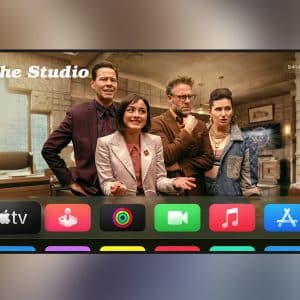 A TV screen displays four people in an office scene labeled "The Studio," with Apple TV 4K and tvOS 27 app icons—including TV, photos, music, and App Store—appearing in a colorful row at the bottom.