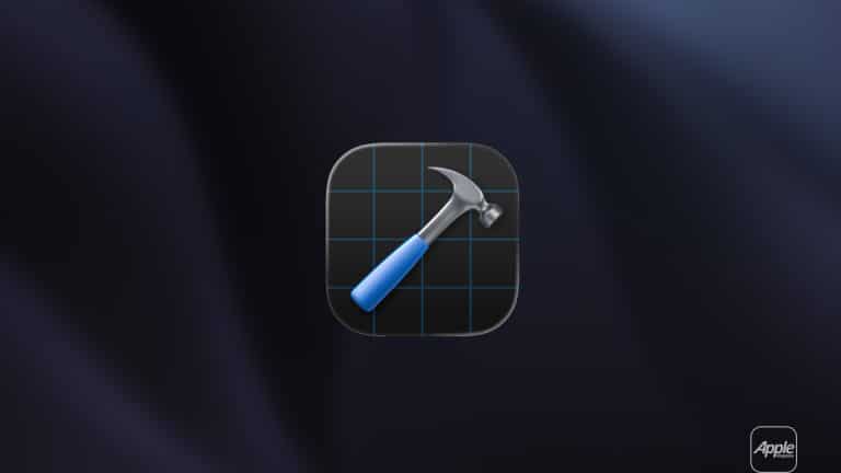 A digital icon of a hammer with a blue handle over a black grid background is centered on a dark, blurred surface. The Apple logo and "Apple" with "WWDC26" appear in the lower right corner, hinting at exciting news for Apple developers.