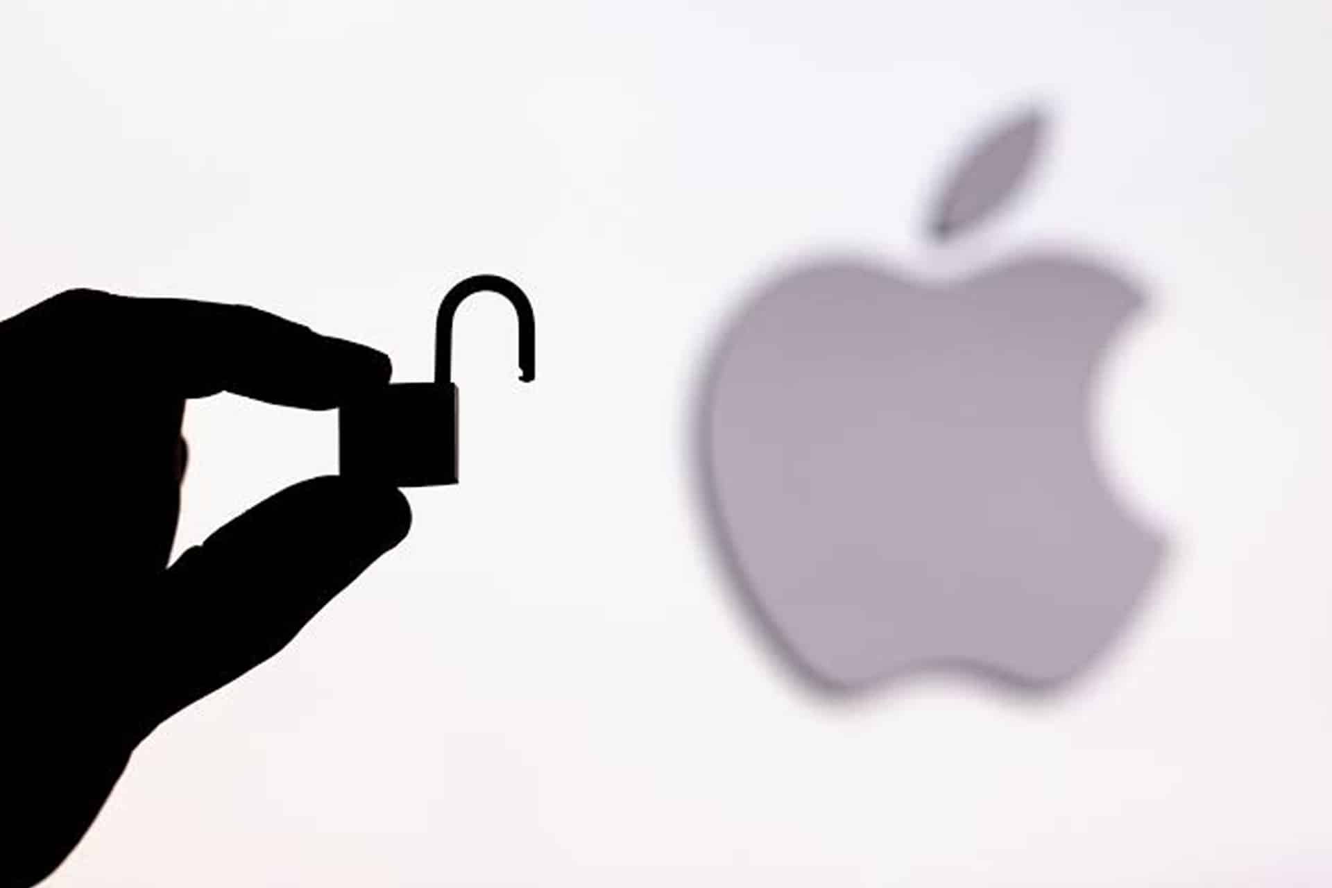 A hand holds an open padlock silhouette in front of a blurred Apple logo, symbolizing shared access and enhanced privacy controls such as Safety Check.