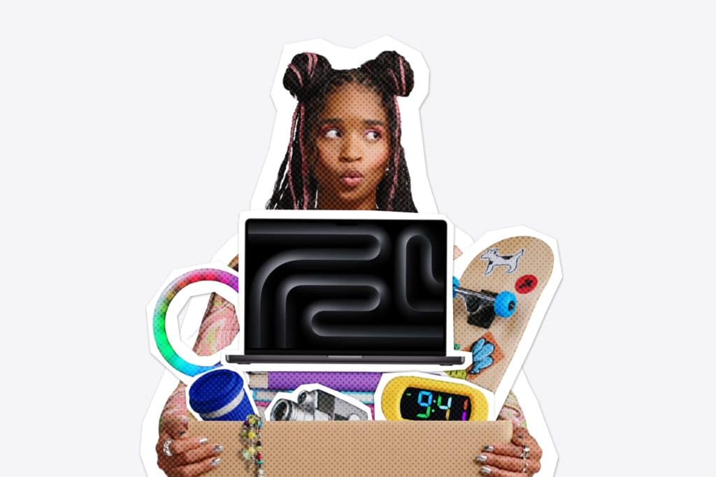 A person with space buns holds a box filled with various items, including a laptop, skateboard, clock, camera, and colorful toys, on a plain light background—capturing the excitement of Back to School season and the rush to catch Apple student deals before the Apple Back to School deadline.