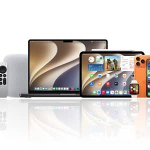 A collection of Apple products, including a MacBook, iPad, iPhone running the latest iOS 17 public beta from the Apple Beta Software Program, Apple Watch, AirPods, HomePod, and Apple TV, displayed on a reflective white surface.