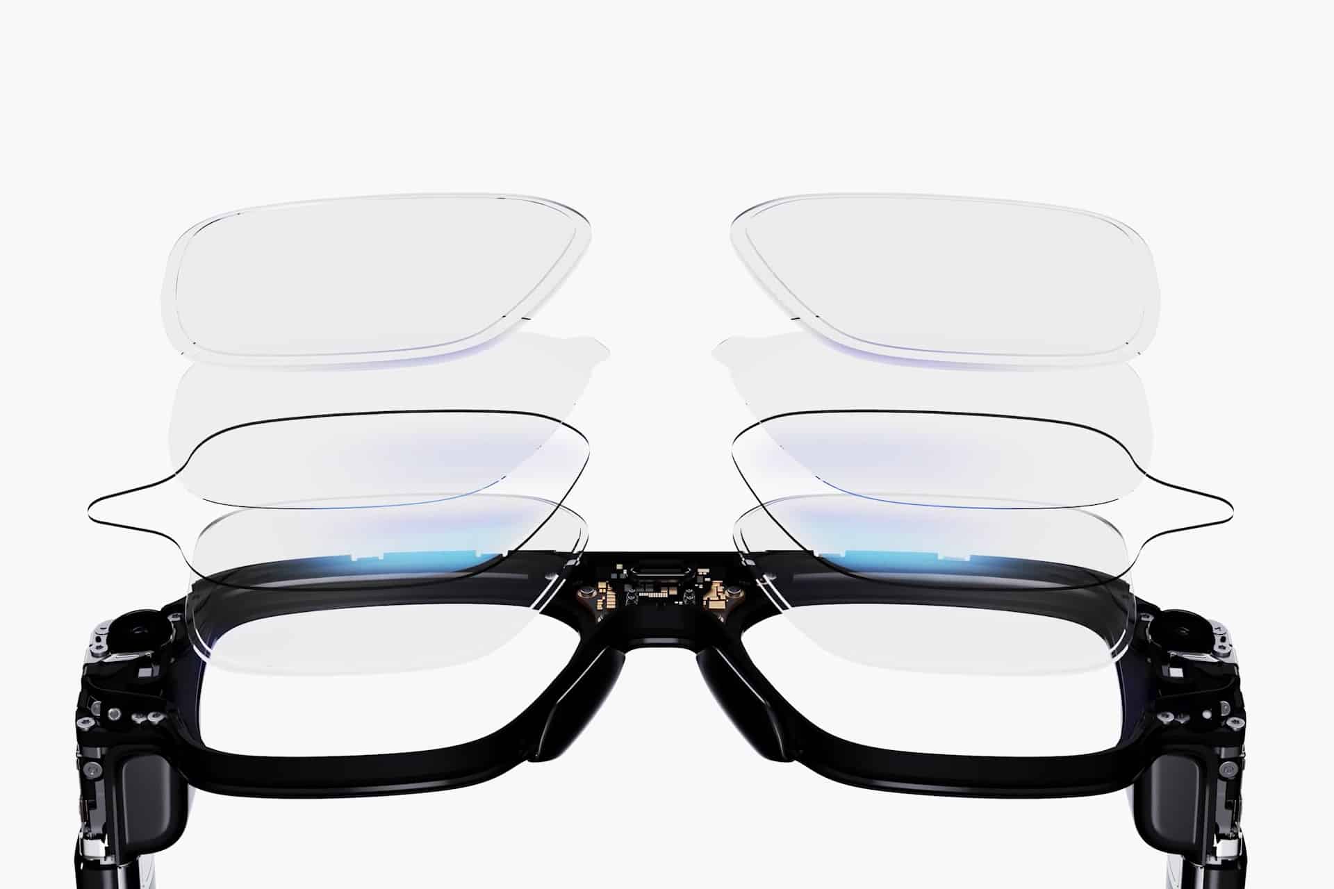 A pair of black smart glasses is shown with multiple transparent lens layers hovering above each frame, illustrating the adjustable or interchangeable lens feature and the power of wearable AI by Even Realities against a white background.