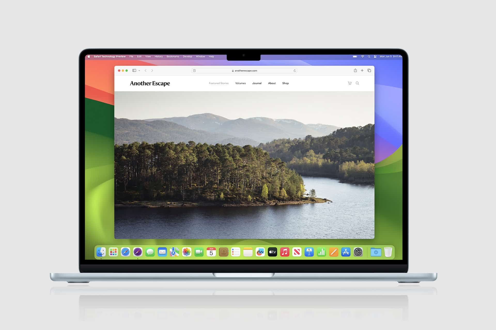 A MacBook displays a website called “Another Escape” featuring a scenic lake and forest landscape, open in Safari. The desktop has a colorful abstract wallpaper and app icons—including Safari MCP Server—along the dock at the bottom of the screen.