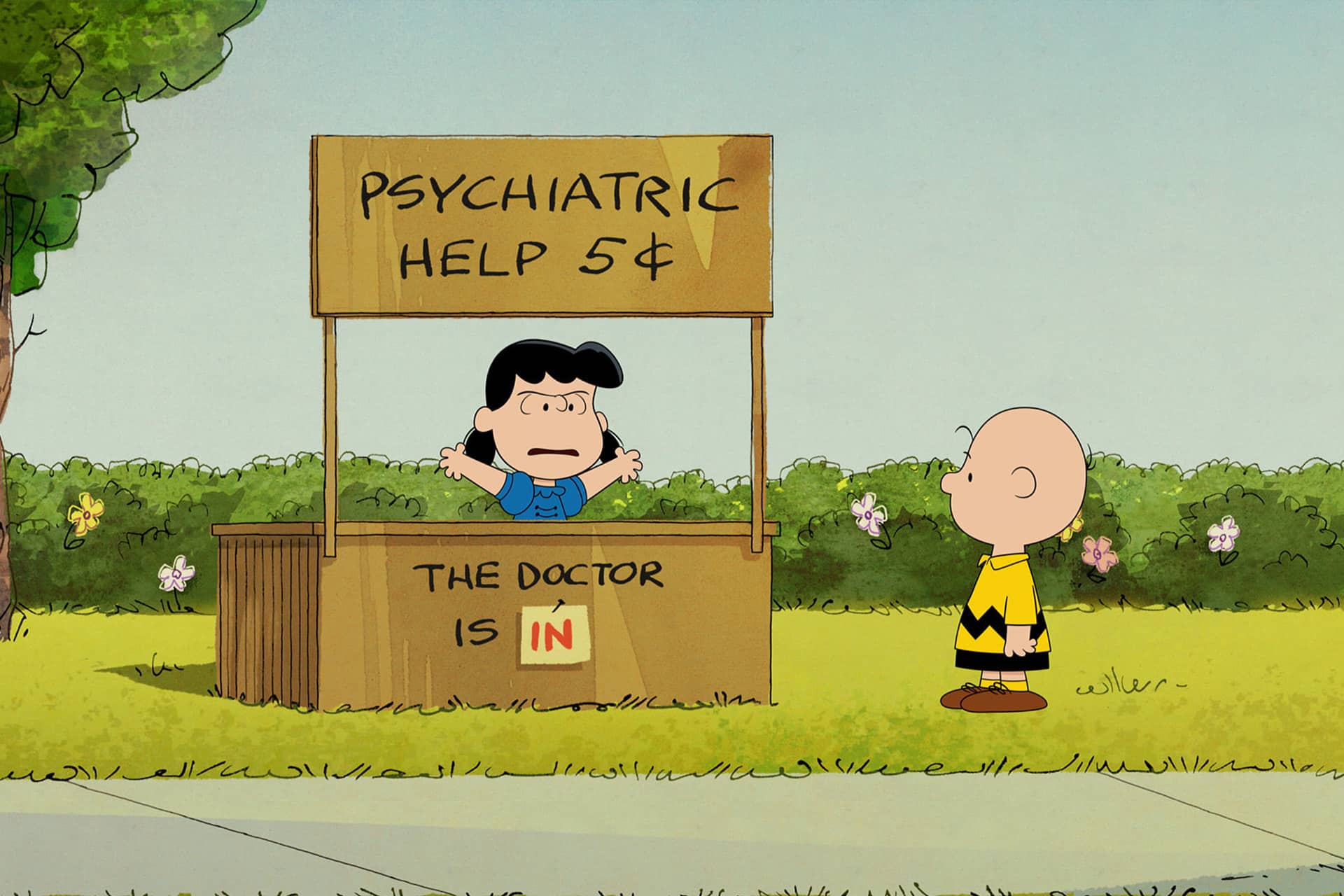A girl sits at a booth labeled "Psychiatric Help 5¢. The Doctor is IN," with her arms raised. A boy in a yellow shirt with a zigzag stands on the grass in front of the booth, as seen in this charming scene from a Peanuts special. Trees and bushes are in the background, bringing to life the timeless world featured in Snoopy Presents on Apple TV.