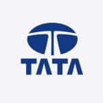 Blue Tata logo with a stylized "T" inside a circle above the word "TATA" in bold, uppercase blue letters on a light gray background, representing Tata Electronics amidst recent headlines about the Tata data leak.