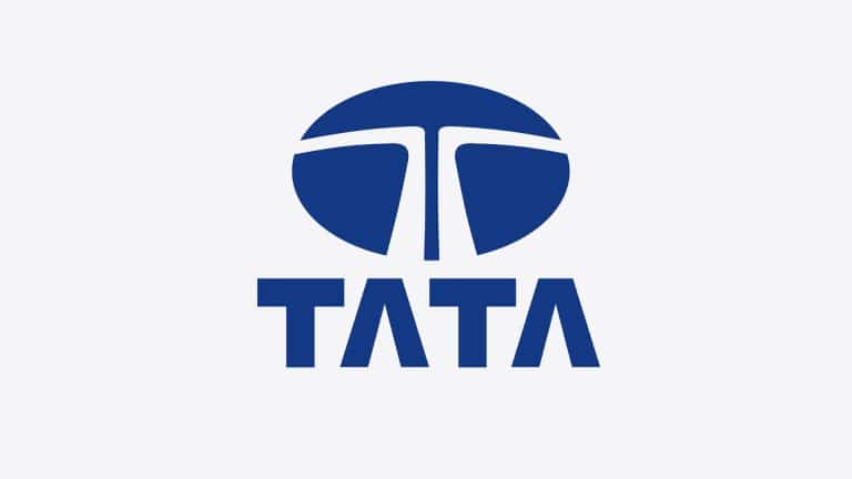 Blue Tata logo with a stylized "T" inside a circle above the word "TATA" in bold, uppercase blue letters on a light gray background, representing Tata Electronics amidst recent headlines about the Tata data leak.