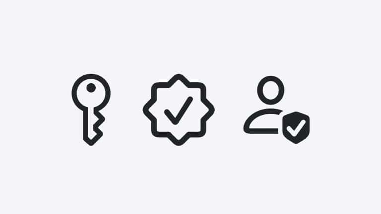 Three black icons on a light gray background: a key, a checkmark badge, and a person with a shield featuring a checkmark. The icons reflect scam detection, security, and user protection—key themes in iOS 27 Trust Insights.