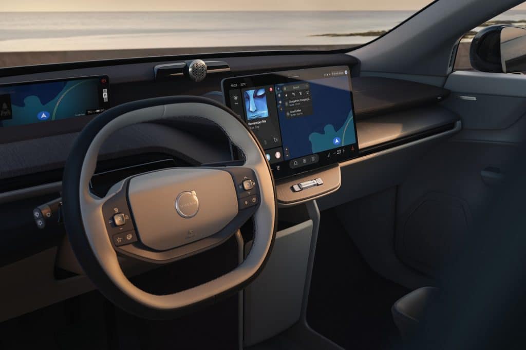 Interior of a Volvo vehicle featuring Apple Music on the central touchscreen alongside integrated navigation and vehicle controls.