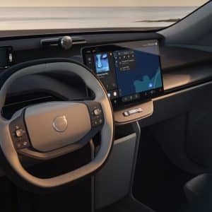 Interior of a Volvo vehicle featuring Apple Music on the central touchscreen alongside integrated navigation and vehicle controls.