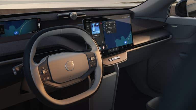 Interior of a Volvo vehicle featuring Apple Music on the central touchscreen alongside integrated navigation and vehicle controls.