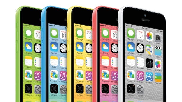 Five iPhones in green, blue, yellow, pink, and white are displayed side by side, each showing their home screens with app icons and the same time and date—a colorful nod to legacy iPhone models and their enduring appeal among enthusiasts interested in iOS signing or exploring features on older iPads.